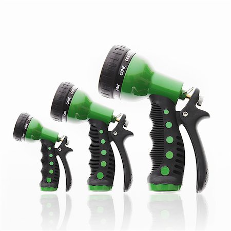Three garden hose triggers and nozzles, in ascending size order. Stock Photo - Premium Royalty-Free, Code: 6118-07351736