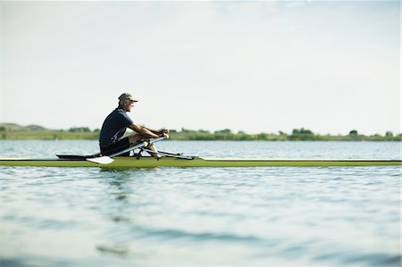 A middle-aged man in a rowing boat on the water. Stockbilder - Premium RF Lizenzfrei, Bildnummer: 6118-07351862