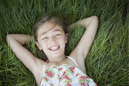 A child in the fresh open air on a sunny day, beside solar panels at a farm in New York State, USA. Stock Photo - Premium Royalty-Free, Code: 6118-07351948