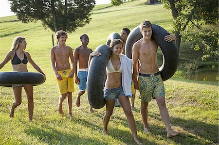 farm photos - A group of young people, boys and girls, holding towels and swim floats, going for a swim. Stock Photo - Premium Royalty-Free, Code: 6118-07351919