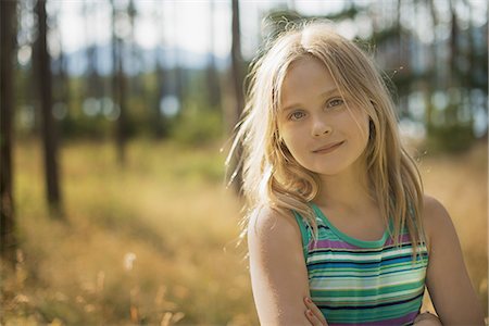 simsearch:6102-08760728,k - A child with long blonde hair in woodland by a lake. Stock Photo - Premium Royalty-Free, Code: 6118-07352088