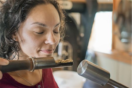 simsearch:6118-07352121,k - A person testing and smelling the aroma of the coffee at a bean processing shed, and testing and tasting area. Stock Photo - Premium Royalty-Free, Code: 6118-07352123