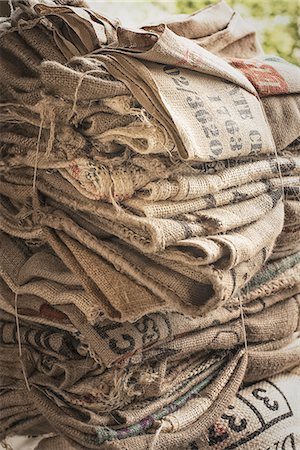 sack - A pile of empty stamped hessian sacks bundled up for reuse or recycling, in a coffee processing plant. Photographie de stock - Premium Libres de Droits, Code: 6118-07352122