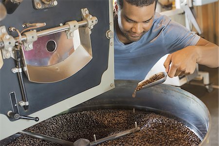 simsearch:6118-07352121,k - Machinery at a coffee bean processing shed heating and  roasting coffee beans being supervised by a young man. Stock Photo - Premium Royalty-Free, Code: 6118-07352126
