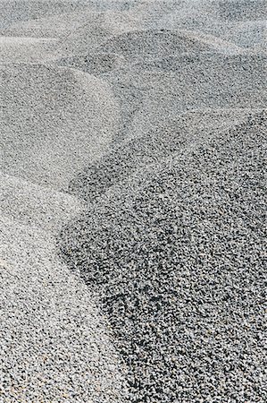simsearch:6118-07353041,k - Gravel piles are used for road maintenance and construction purposes. Photographie de stock - Premium Libres de Droits, Code: 6118-07352245