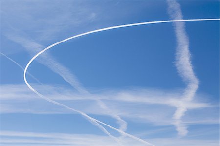 simsearch:6118-07351309,k - Jet trail across blue sky Photographie de stock - Premium Libres de Droits, Code: 6118-07352246