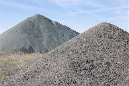 Gravel piles are used for road maintenance and construction purposes. Stock Photo - Premium Royalty-Free, Code: 6118-07352250