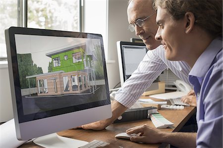 Architects discussing a green construction project, designing and building efficient environmentally friendly buildings. Green architectural practice. Stock Photo - Premium Royalty-Free, Code: 6118-07352457