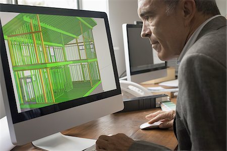 Architects discussing a green construction project, designing and building efficient environmentally friendly buildings. Green architectural practice. Stock Photo - Premium Royalty-Free, Code: 6118-07352454