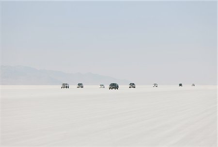 flat - Cars driving on Bonneville Salt Flats during Speed Week. Dusk. Stock Photo - Premium Royalty-Free, Code: 6118-07352499