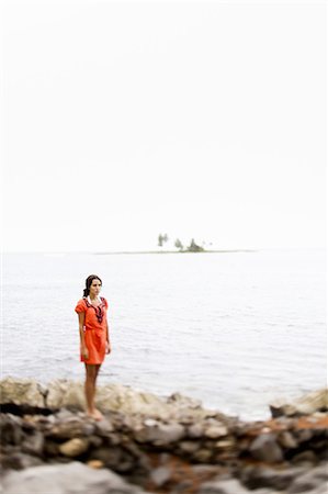 simsearch:6118-07731789,k - A woman on the beach on a cloudy day in Las Galeras, Samana Peninsula, Dominican Republic. Photographie de stock - Premium Libres de Droits, Code: 6118-07352412