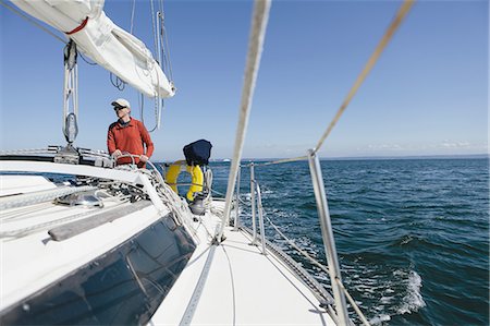 simsearch:6118-07352544,k - Middle aged man steering sailboat on Puget Sound, Washington, USA Stock Photo - Premium Royalty-Free, Code: 6118-07352545