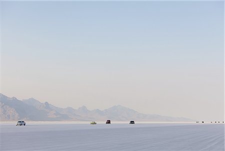 salt plains - Cars driving on Bonneville Salt Flats during Speed Week. Dusk. Stock Photo - Premium Royalty-Free, Code: 6118-07352500