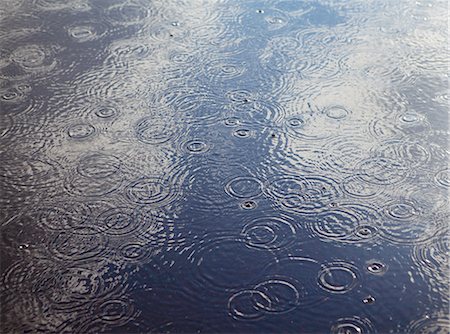 raining sky - Rain drops and ripples on a pool of water. Stock Photo - Premium Royalty-Free, Code: 6118-07352515
