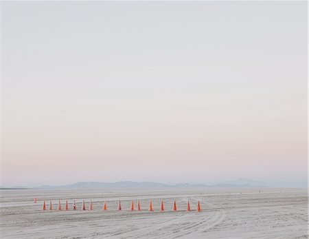 dusk empty - Row of traffic cones on the flat desert surface of  Black Rock, Nevada. Stock Photo - Premium Royalty-Free, Code: 6118-07352742