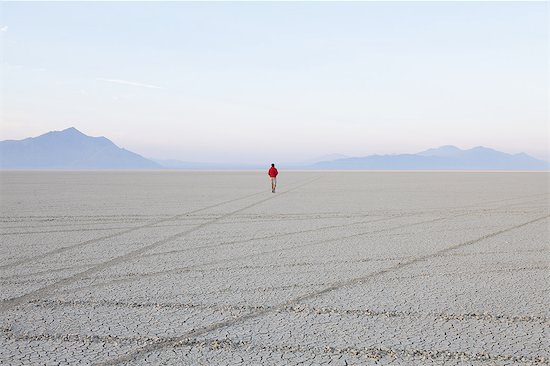 A man in the flat playa, salt pan, of Black Rock Desert, Nevada. Stock Photo - Premium Royalty-Free, Image code: 6118-07352748