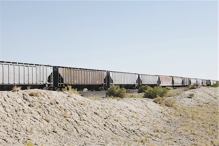 simsearch:6118-07122058,k - Wagons of a train crossing the Black Rock Desert. Photographie de stock - Premium Libres de Droits, Code: 6118-07352758