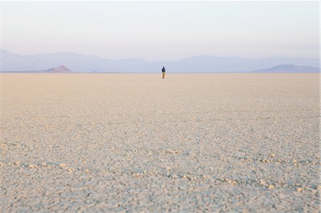 salinas - The figure of a man in the empty desert landscape of Black Rock desert, Nevada. Photographie de stock - Premium Libres de Droits, Code: 6118-07352776
