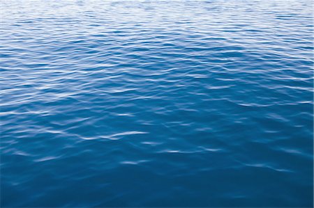 Blue lake water with small ripples Stock Photo - Premium Royalty-Free, Code: 6118-07352735