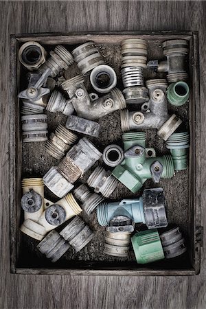 simsearch:6118-07440380,k - Washers and hose pipe joint fittings in a wooden box in the greenhouse. Stock Photo - Premium Royalty-Free, Code: 6118-07352883