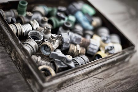 Washers and hose pipe joint fittings in a wooden box in the greenhouse. Stock Photo - Premium Royalty-Free, Code: 6118-07352884