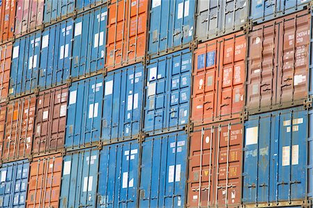 simsearch:6118-08827528,k - A stack of cargo containers, commercial freight containers, packed together and waiting to be moved. Stock Photo - Premium Royalty-Free, Code: 6118-07352946