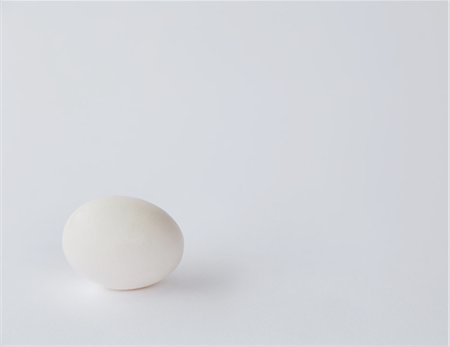 egg and nobody - A single free range organic egg with a white shell against a white background. Stock Photo - Premium Royalty-Free, Code: 6118-07353044