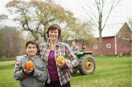 simsearch:6118-07351946,k - Two people, a woman and a child on an organic farm, carrying harvested vegetables, squashes and pumpkins.  Organic farming. Foto de stock - Royalty Free Premium, Número: 6118-07353440