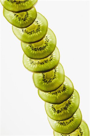 row of seeds - Organic kiwi slices, white background Stock Photo - Premium Royalty-Free, Code: 6118-07353653