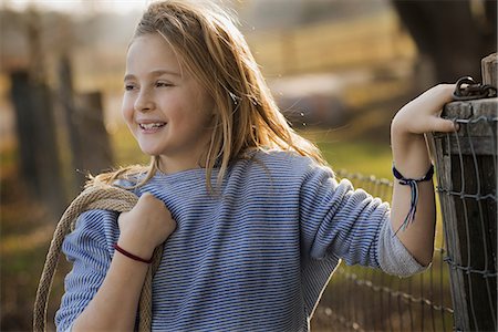 simsearch:6118-07354199,k - A young girl by a paddock fence. Stock Photo - Premium Royalty-Free, Code: 6118-07353772