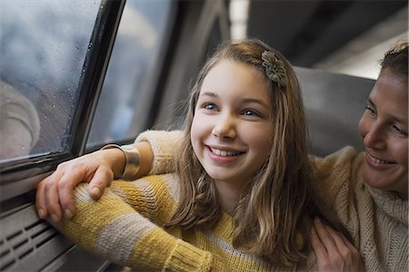 A man and a young girl sitting beside the window in a train carriage looking out at the countryside. Smiling in excitement. Stock Photo - Premium Royalty-Free, Code: 6118-07354150