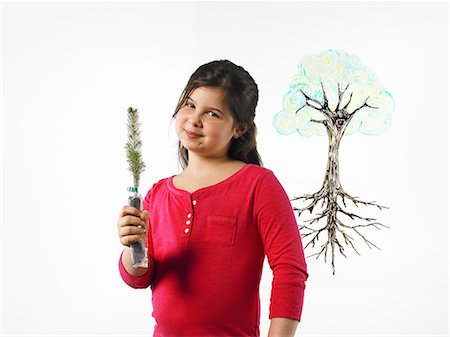 planting trees - A young girl holding a small evergreen seedling. An illustration of a plant with roots drawn on a clear surface. Stock Photo - Premium Royalty-Free, Code: 6118-07354245