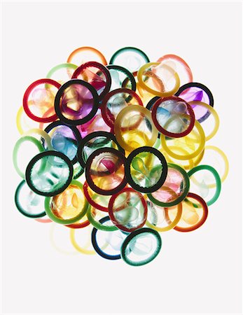 A pile of multi-colored condoms on a white background. Stock Photo - Premium Royalty-Free, Code: 6118-07354271