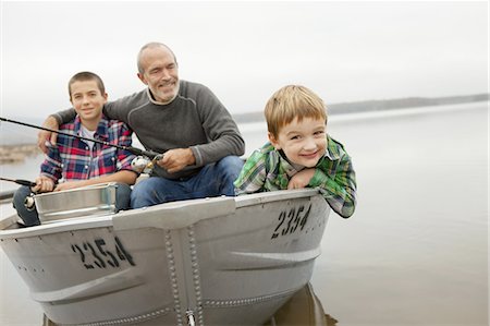 A day out at Ashokan lake. A man and two boys fishing from a boat. Stock Photo - Premium Royalty-Free, Code: 6118-07440280