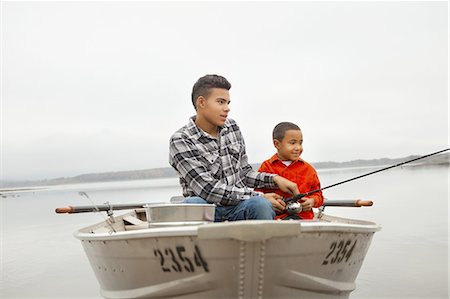 A day out at Ashokan lake. Two boys sitting fishing from a boat. Stock Photo - Premium Royalty-Free, Code: 6118-07440281