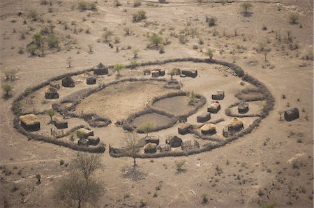 simsearch:700-08169184,k - An aerial view of a small rural village settlement, with traditional buildings and animal enclosures. Photographie de stock - Premium Libres de Droits, Code: 6118-07440291