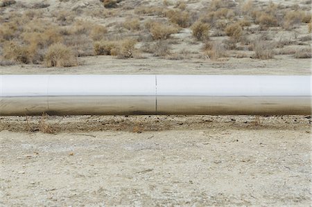 Elevated steam pipeline in the Midway-Sunset oil fields, the largest shale oil field in California. Stock Photo - Premium Royalty-Free, Code: 6118-07440223