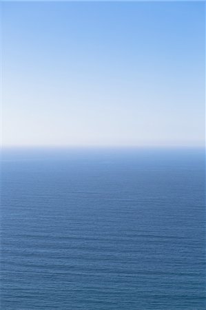 sky and ocean - A view over the Pacific Ocean and a calm sea, merging into the blue sky. Stock Photo - Premium Royalty-Free, Code: 6118-07440232