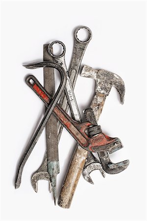 Used Tools. A group of spanners, adjustable wrench and hammer. Worn marked metal handheld tools. Photographie de stock - Premium Libres de Droits, Code: 6118-07440400