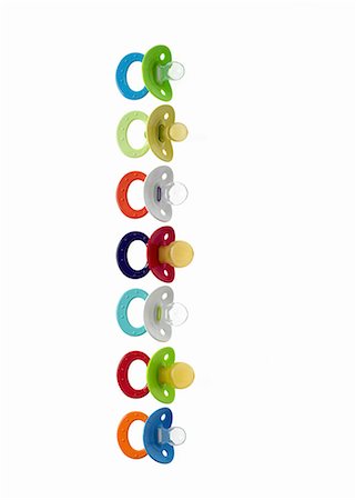 simsearch:6118-07353323,k - Coloured plastic baby pacifiers, dummies or soothers. Photographie de stock - Premium Libres de Droits, Code: 6118-07440584