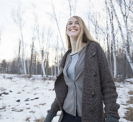 simsearch:6118-07354079,k - A young woman with long blonde hair outdoors on a winter day. Foto de stock - Sin royalties Premium, Código: 6118-07440765