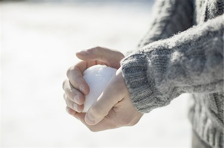 snowballs - A man holding a large snowball in his bare hands. Stock Photo - Premium Royalty-Free, Code: 6118-07440790