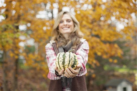 Organic farm. A woman holding a large striped squash vegetable. Stock Photo - Premium Royalty-Free, Code: 6118-07439811