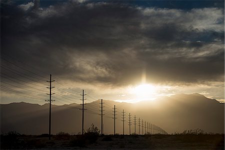 power lines in the sky - Power lines in rows across the landscape, against a darkening sky. Stock Photo - Premium Royalty-Free, Code: 6118-07762646