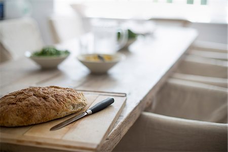 A house dining room. Food on the table. Baked bread. Stock Photo - Premium Royalty-Free, Code: 6118-07769555