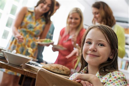 simsearch:6118-07769572,k - A family gathering for a meal. Adults and children around a table. Foto de stock - Sin royalties Premium, Código: 6118-07769570