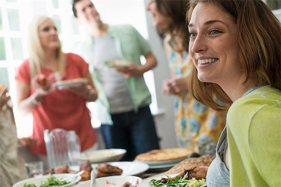 A family gathering for a meal. Adults and children around a table. Stock Photo - Premium Royalty-Free, Image code: 6118-07769572