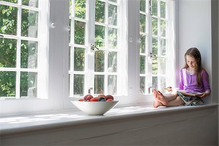 single window - Girl sitting by a window, reading a book. Stock Photo - Premium Royalty-Free, Code: 6118-07769578