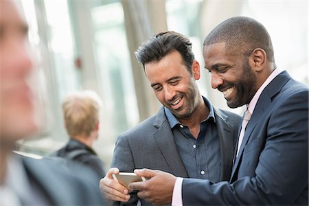 simsearch:6118-08351860,k - Two men checking a smart phone. Stock Photo - Premium Royalty-Free, Code: 6118-07769502