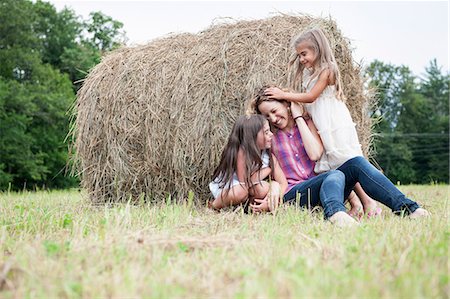 simsearch:6118-07781839,k - Mother playing outdoors with her daughters. Stock Photo - Premium Royalty-Free, Code: 6118-07769618